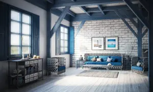 Salon w stylu coastal, z niebieskimi akcentami, ceglaną ścianą i widokiem na morze na obrazach.