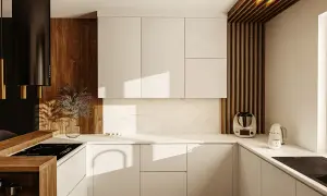 Nowoczesna kuchnia z białymi frontami, drewnianymi akcentami i czarnym okapem. Widoczny system gola w szafkach, idealnie wkomponowany w design.