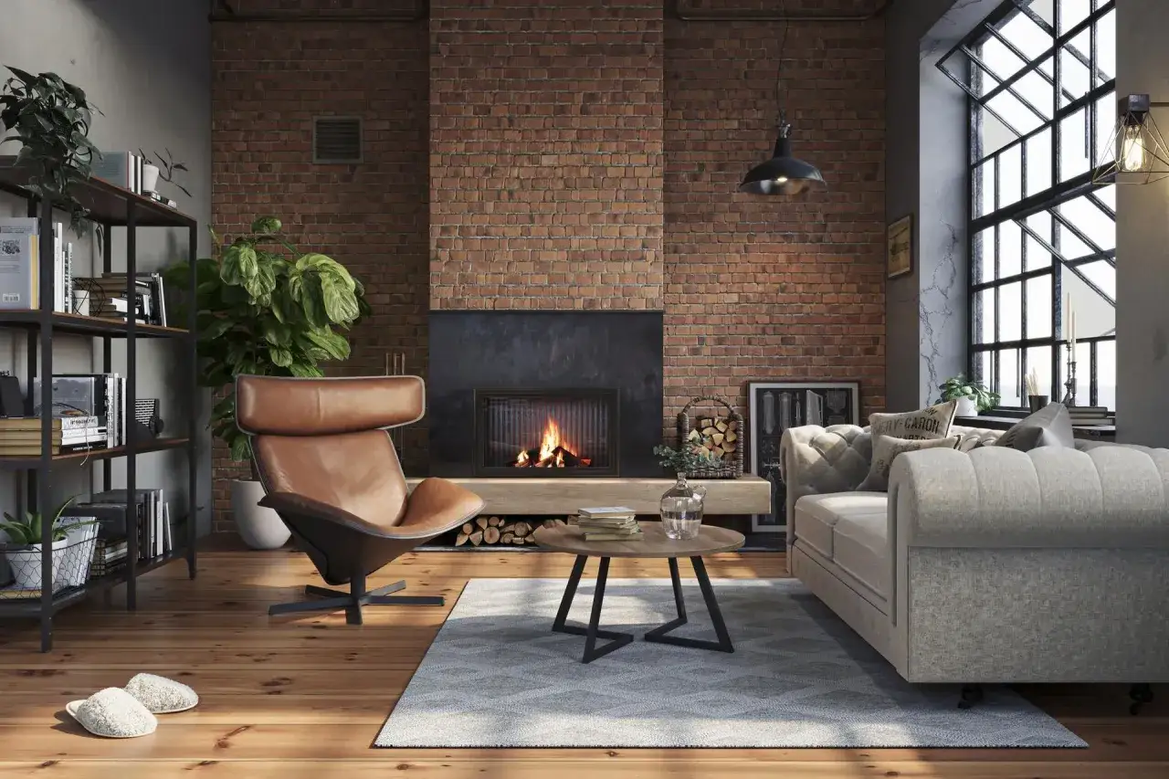 Przytulny salon w stylu loft. Ceglana ściana, kominek, sk&oacute;rzany fotel i wygodna kanapa &ndash; idealne salon loft inspiracje.